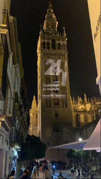 Giralda de Sevilla con el logo de Las 24 Horas de Manos Unidas